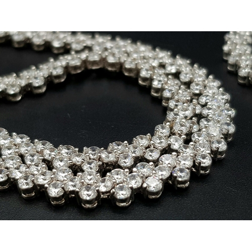 605 - An Upmarket White Metal and Faux Diamond Jewellery Suite. Consists of necklace, bracelet and earring... 