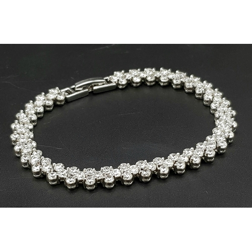 605 - An Upmarket White Metal and Faux Diamond Jewellery Suite. Consists of necklace, bracelet and earring... 