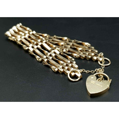 810 - A 9K GOLD 8 GATE BRACELET WITH HEART PADLOCK AND SAFETY CHAIN. .   12.4gms