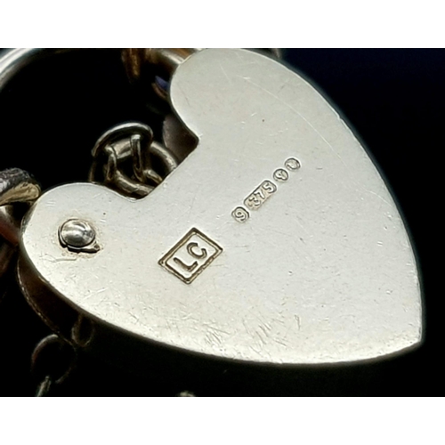 810 - A 9K GOLD 8 GATE BRACELET WITH HEART PADLOCK AND SAFETY CHAIN. .   12.4gms