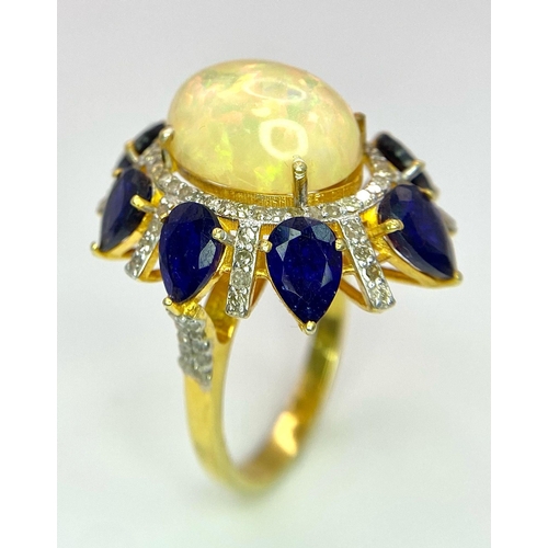 27 - A Head-Turning Opal, Tanzanite and Diamond Ring. Centre 7ct colour-play opal with a tanzanite and di... 