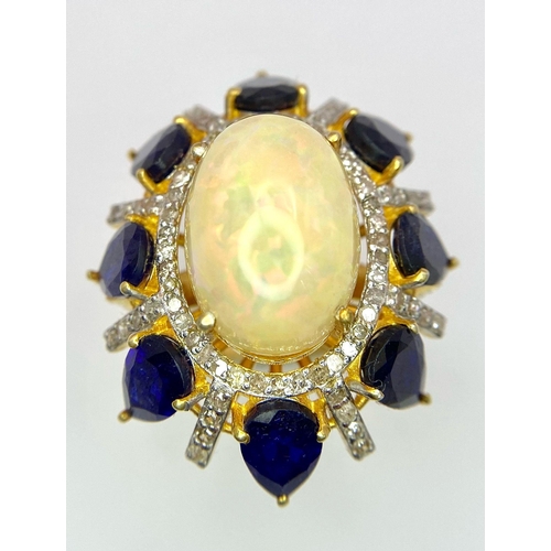 27 - A Head-Turning Opal, Tanzanite and Diamond Ring. Centre 7ct colour-play opal with a tanzanite and di... 