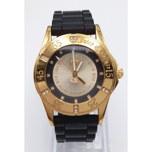 484 - An Excellent Condition Stone Set Bezel Gold Tone Sports Watch by Juicy Couture. 39mm Including Crown... 