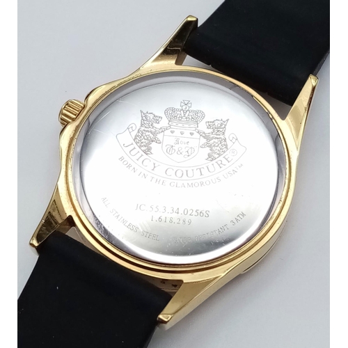 484 - An Excellent Condition Stone Set Bezel Gold Tone Sports Watch by Juicy Couture. 39mm Including Crown... 