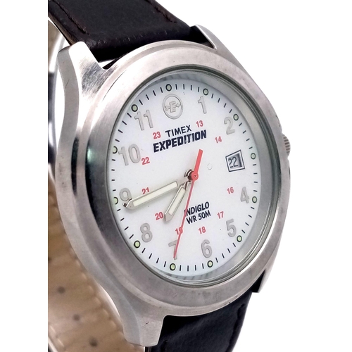 1060 - A Timex Expedition Indiglo Watch. Brown leather strap. Stainless steel case - 39mm. White dial with ... 