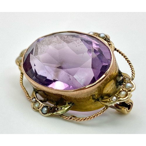 612 - AN ANTIQUE EDWARDIAN AMETHYST BROOCH DECORATED WITH SEED PEARLS AND TWIST GOLDEN WIRE HALO .   8.7gm... 