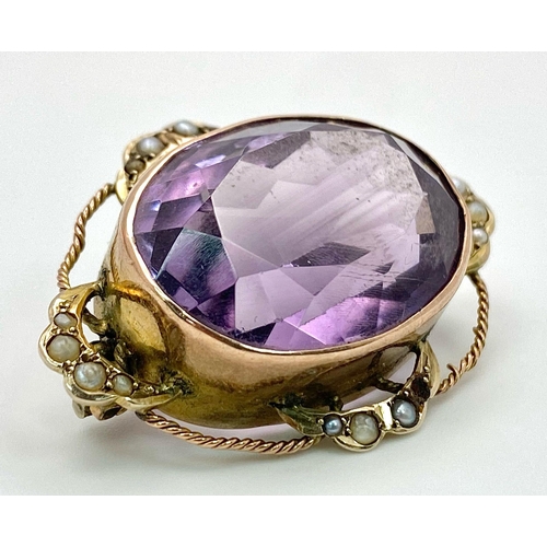 612 - AN ANTIQUE EDWARDIAN AMETHYST BROOCH DECORATED WITH SEED PEARLS AND TWIST GOLDEN WIRE HALO .   8.7gm... 