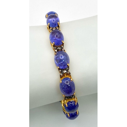 645 - A Blue Tanzanite Cabochon Gemstone Tennis Bracelet with Diamond Separators set in 925 gilded Silver.... 