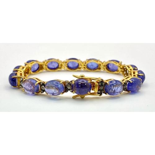 645 - A Blue Tanzanite Cabochon Gemstone Tennis Bracelet with Diamond Separators set in 925 gilded Silver.... 