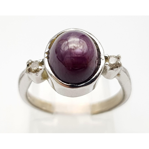 648 - A Vintage Sterling Silver Amethyst Cabochon & Two Diamond Trilogy Ring Size J. The Crown is set with... 