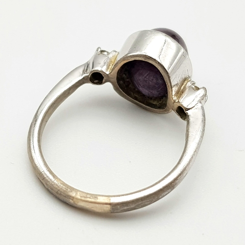 648 - A Vintage Sterling Silver Amethyst Cabochon & Two Diamond Trilogy Ring Size J. The Crown is set with... 