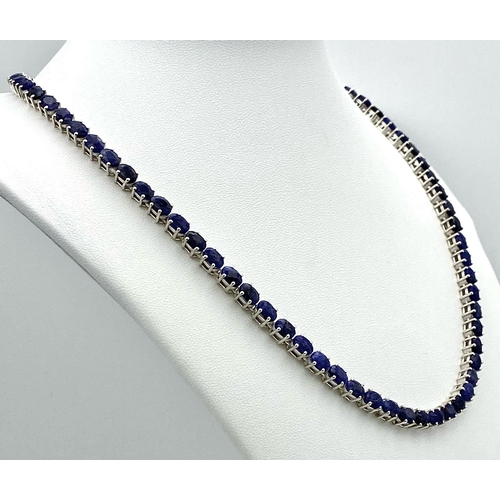 744 - An Oval Cut Blue Sapphire Gemstone Tennis Necklace set in 925 Silver. 46cm length. 34.5g weight.