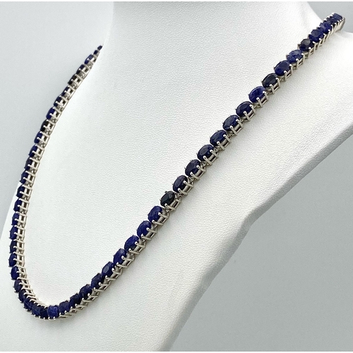 744 - An Oval Cut Blue Sapphire Gemstone Tennis Necklace set in 925 Silver. 46cm length. 34.5g weight.