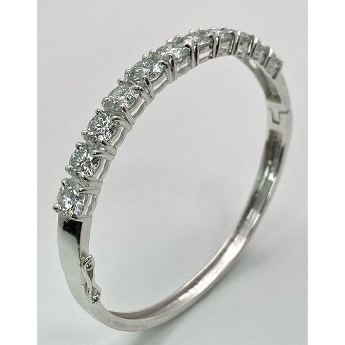 935 - An 11ctw White Moissanite Bracelet set in 925 Silver. Clip open. 6cm inner diameter. 13.5g weight. R... 