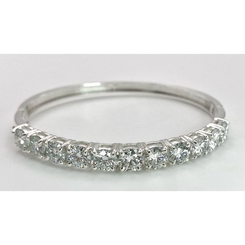 935 - An 11ctw White Moissanite Bracelet set in 925 Silver. Clip open. 6cm inner diameter. 13.5g weight. R... 