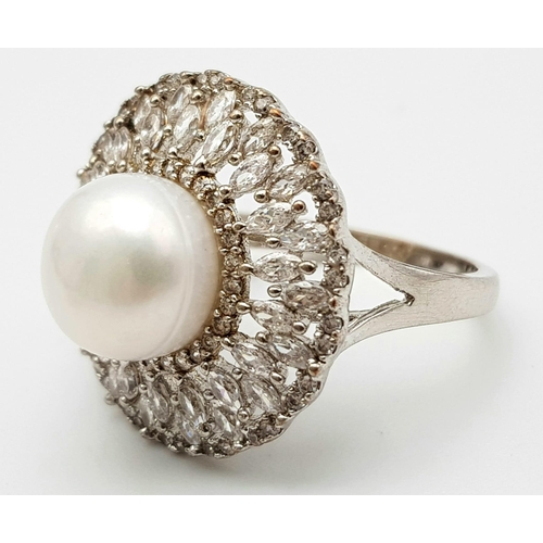 971 - Art Deco Design Silver Pearl & Clear Stone Set Ring Size O. Crown measures 2.1cm Diameter. Gross Wei... 