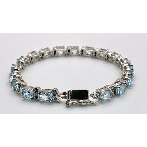 772 - An Ice Blue Topaz Gemstone Tennis Bracelet set in 925 Silver. 18cm length. 25.64g weight. Ref: CD-11... 