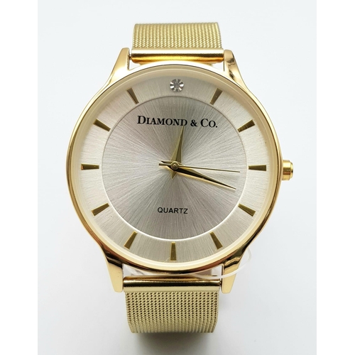 909 - An Unworn, Diamond & Co. London, Gold Tone Quartz Watch, Set with a Real Diamond on the Face at 12 O... 