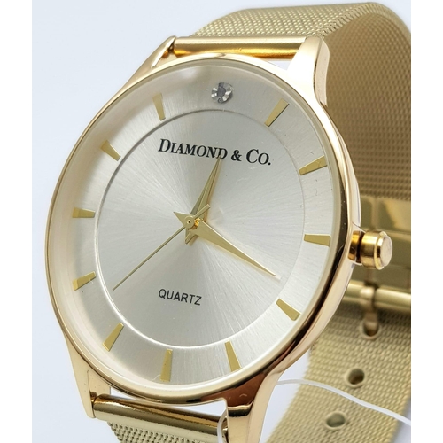 909 - An Unworn, Diamond & Co. London, Gold Tone Quartz Watch, Set with a Real Diamond on the Face at 12 O... 