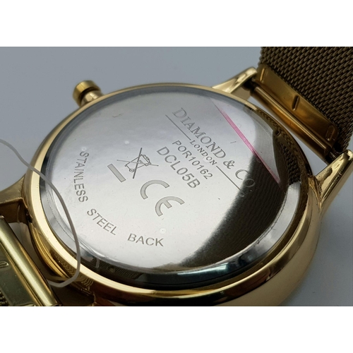 909 - An Unworn, Diamond & Co. London, Gold Tone Quartz Watch, Set with a Real Diamond on the Face at 12 O... 