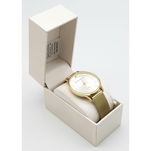 909 - An Unworn, Diamond & Co. London, Gold Tone Quartz Watch, Set with a Real Diamond on the Face at 12 O... 