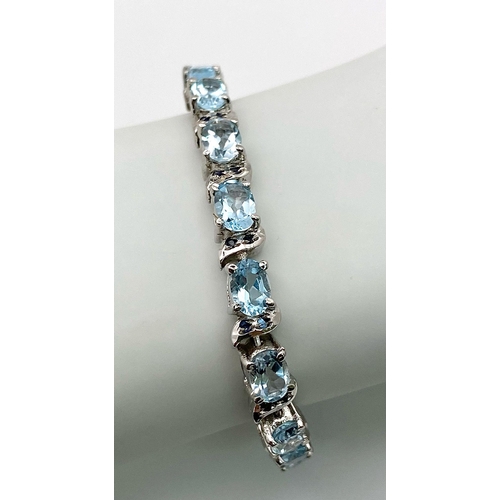 772 - An Ice Blue Topaz Gemstone Tennis Bracelet set in 925 Silver. 18cm length. 25.64g weight. Ref: CD-11... 