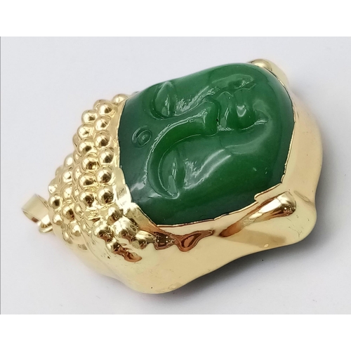 702 - A Gilded Jade Buddha Head Pendant. 4.5cm.