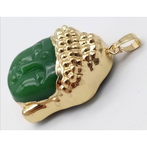 702 - A Gilded Jade Buddha Head Pendant. 4.5cm.