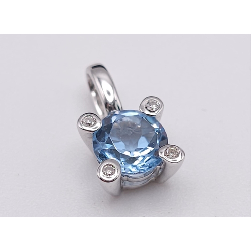 562 - A 18K WHITE GOLD DIAMOND & BLUE TOPAZ PENDANT. TOTAL WEIGHT 1.1G