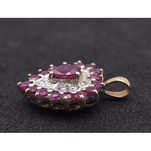 796 - A 9K YELLOW GOLD DIAMOND & RUBY HEART PENDANT. TOTAL WEIGHT 2G