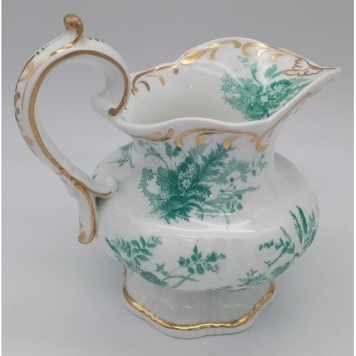 1335 - AN ETRUSCAN SHAPED SMALL FOOTED JUG WITH FLORAL PRINT AND GILT TRIM . 15 X 13cms