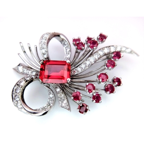 327 - A STUNNING DIAMOND AND RUBY BROOCH SET IN PLATINUM , A MAJESTIC SPRAY OF RUBIES EMINATING FROM A DIA... 