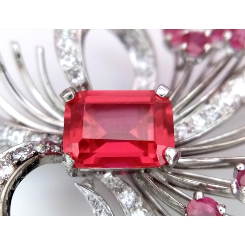 327 - A STUNNING DIAMOND AND RUBY BROOCH SET IN PLATINUM , A MAJESTIC SPRAY OF RUBIES EMINATING FROM A DIA... 