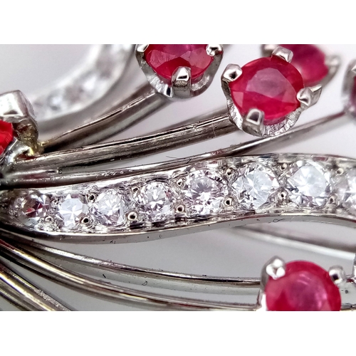 327 - A STUNNING DIAMOND AND RUBY BROOCH SET IN PLATINUM , A MAJESTIC SPRAY OF RUBIES EMINATING FROM A DIA... 