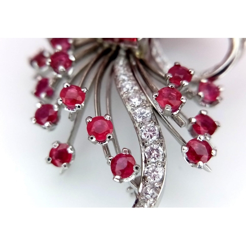 327 - A STUNNING DIAMOND AND RUBY BROOCH SET IN PLATINUM , A MAJESTIC SPRAY OF RUBIES EMINATING FROM A DIA... 