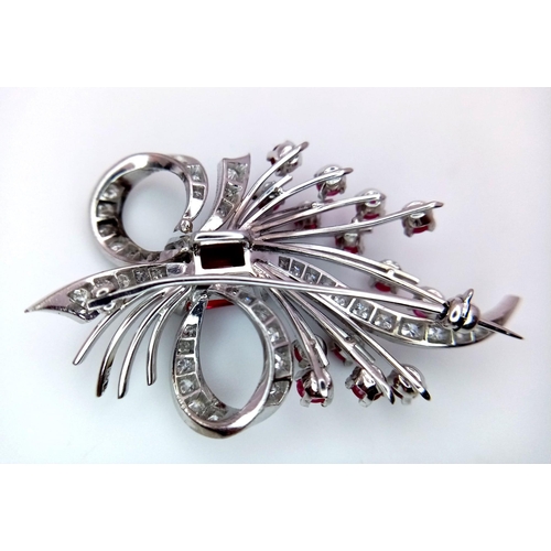 327 - A STUNNING DIAMOND AND RUBY BROOCH SET IN PLATINUM , A MAJESTIC SPRAY OF RUBIES EMINATING FROM A DIA... 