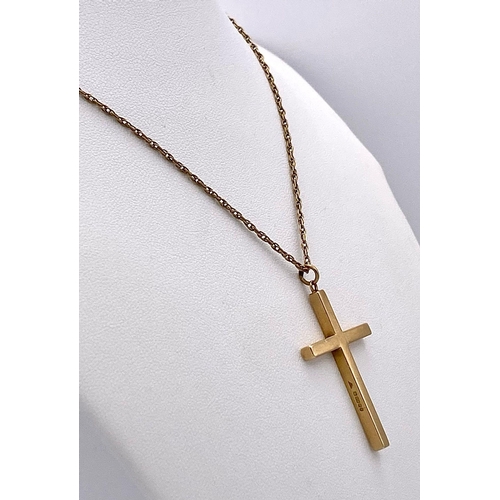 625 - A 9K GOLD CROSS PENDANT ON A 72cms 9K GOLD TWIST CHAIN .   10.8gms