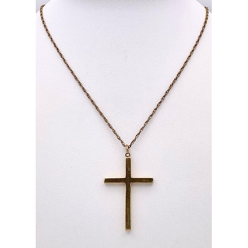 625 - A 9K GOLD CROSS PENDANT ON A 72cms 9K GOLD TWIST CHAIN .   10.8gms