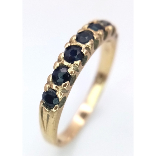 725 - A 9K GOLD RING WITH SEVEN SAPPHIRE STONES .    2gms   size N/Q