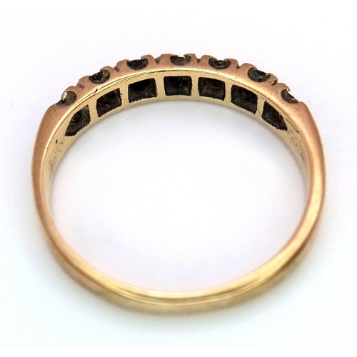 725 - A 9K GOLD RING WITH SEVEN SAPPHIRE STONES .    2gms   size N/Q