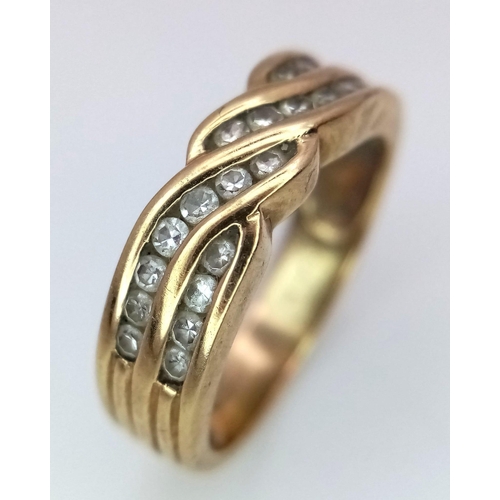 824 - A 9K YELLOW GOLD 0.25CT DIAMOND 2 ROW BAND RING. TOTAL WEIGHT 3.2G. SIZE K