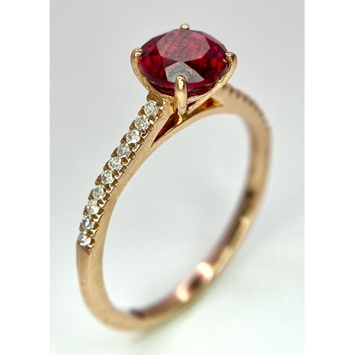 1070 - A 9K ROSE GOLD DIAMOND & RED STONE RING. TOTAL WEIGHT 1.7G. SIZE M