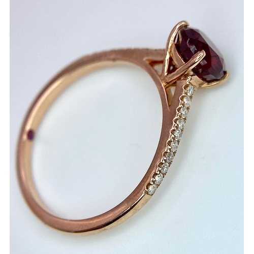 1070 - A 9K ROSE GOLD DIAMOND & RED STONE RING. TOTAL WEIGHT 1.7G. SIZE M