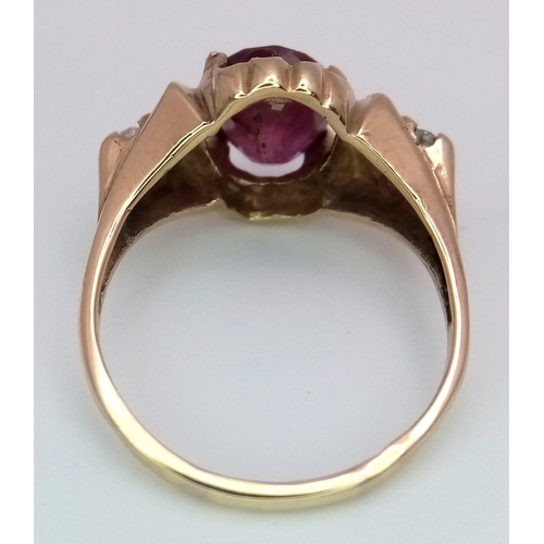 1150 - AN 18K GOLD OVAL RUBY AND 2 DIAMOND RING .   3.5gms   size N