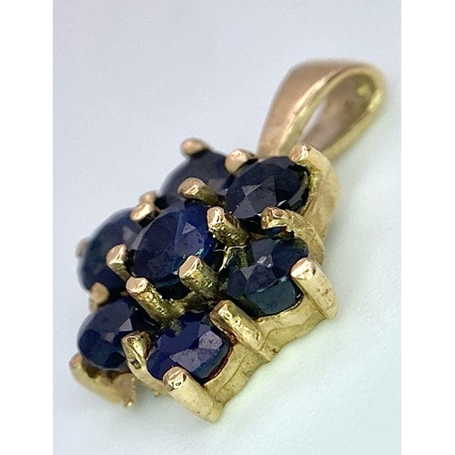 585 - A 9K YELLOW GOLD BLUE STONE SET PENDANT. TOTAL WEIGHT 1.1G