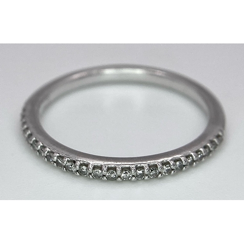 698 - A 950 PLATINUM DIAMOND SET BAND RING. TOTAL WEIGHT 2.5G. SIZE K