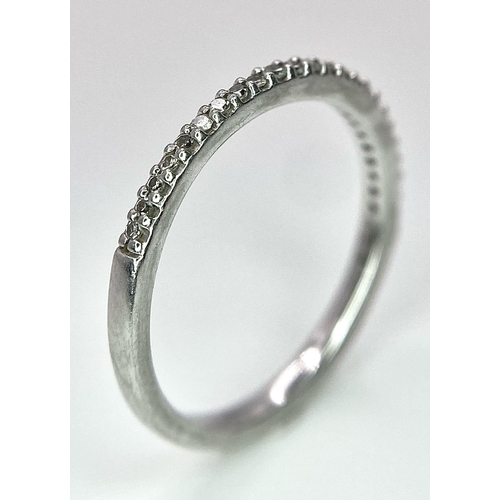 698 - A 950 PLATINUM DIAMOND SET BAND RING. TOTAL WEIGHT 2.5G. SIZE K