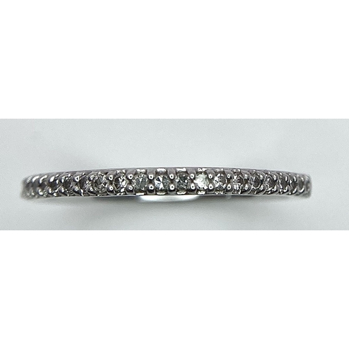 698 - A 950 PLATINUM DIAMOND SET BAND RING. TOTAL WEIGHT 2.5G. SIZE K