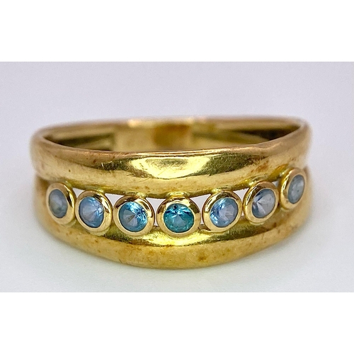 726 - A 18K YELLOW GOLD BLUE TOPAZ SET RING. TOTAL WEIGHT 1.5G. SIZE N