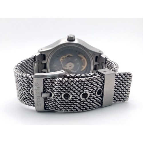 852 - A Swatch Irony Automatic Gents Watch. Stainless steel mesh strap. Stainless steel case - 42mm. Black... 